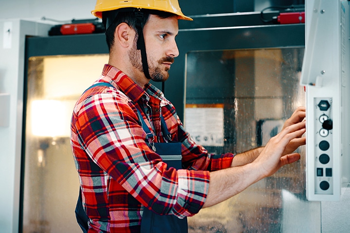 modern industrial machine operator working in factory